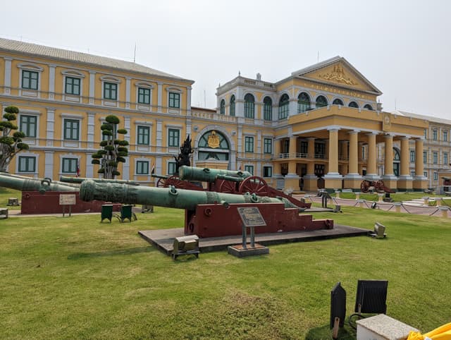 Low-angle shot from the central walkway, framing the lawn boundary against the sky. — Sanam Luang, Bangkok, Thailand